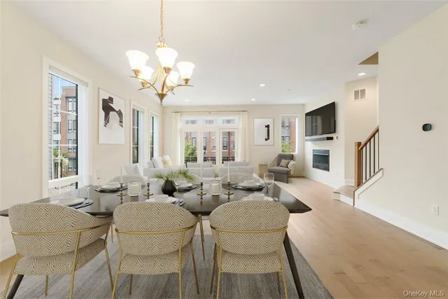 a living room with fireplace furniture and a chandelier