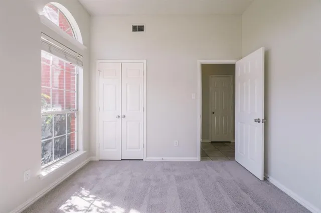 an empty room with windows and entrance