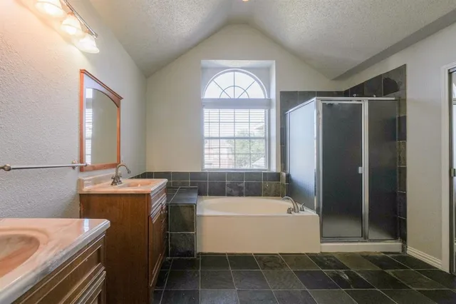 a bathroom with a bathtub sink and mirror