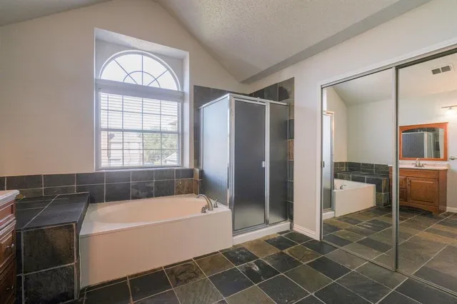 a bathroom with a bathtub and a shower