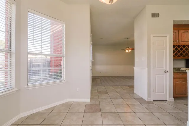 a view of an empty room with closet and a window