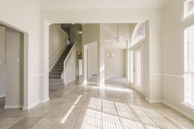 a view of a room with wooden floor and windows