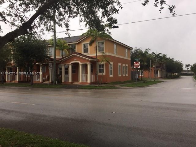 a front view of a house with a road