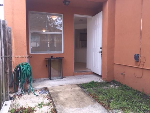 10852 Southwest 240th Street Homestead, FL 33032 - Photo 13 of 15 a couple of potted plants in front of door