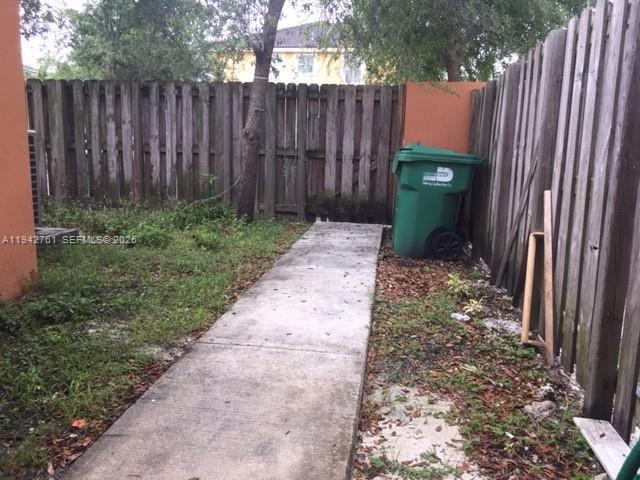 10852 Southwest 240th Street Homestead, FL 33032 - Photo 14 of 15 a backyard of a house with a table and chairs