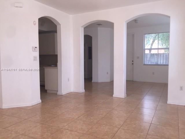 10852 Southwest 240th Street Homestead, FL 33032 - Photo 4 of 15 a view of an empty room with windows and closet