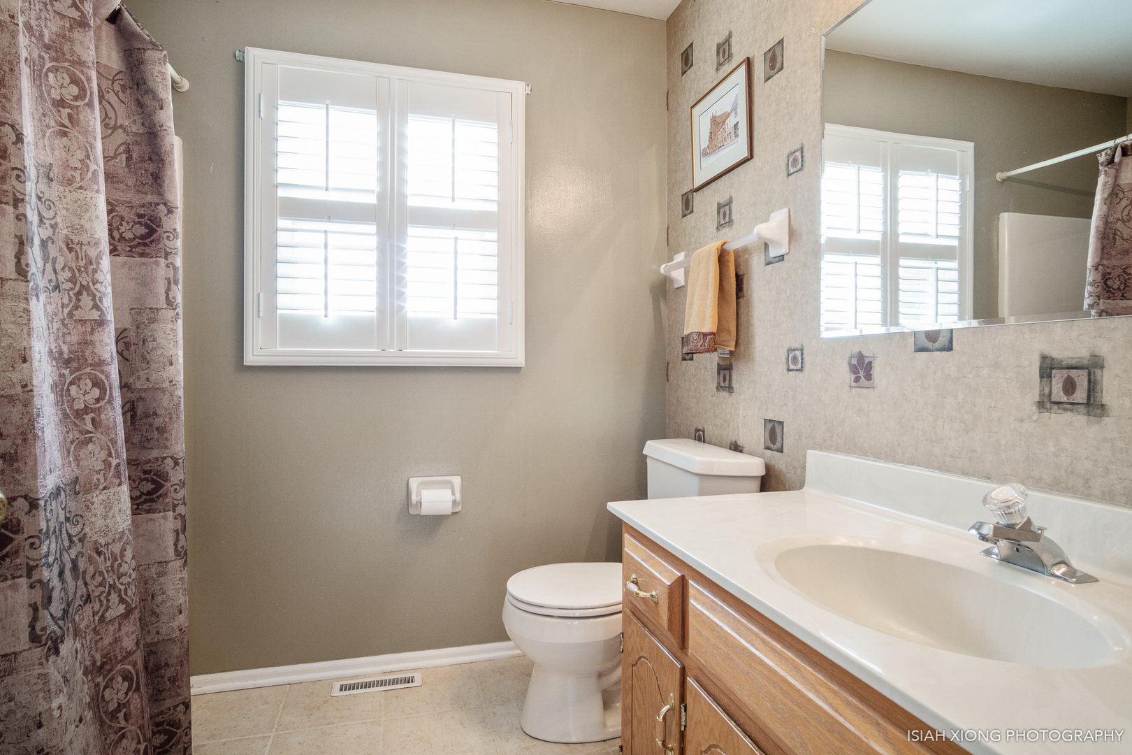 26W407 Jewell Road Winfield, IL 60190 - Photo 22 of 30 a bathroom with a toilet a sink a mirror a window and vanity