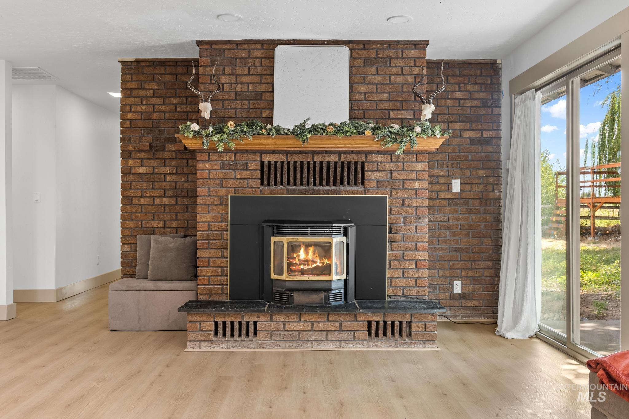 8500 Washoe Road Payette, ID 83661 - Photo 16 of 50 Detailed view of wood finished floors and a brick fireplace