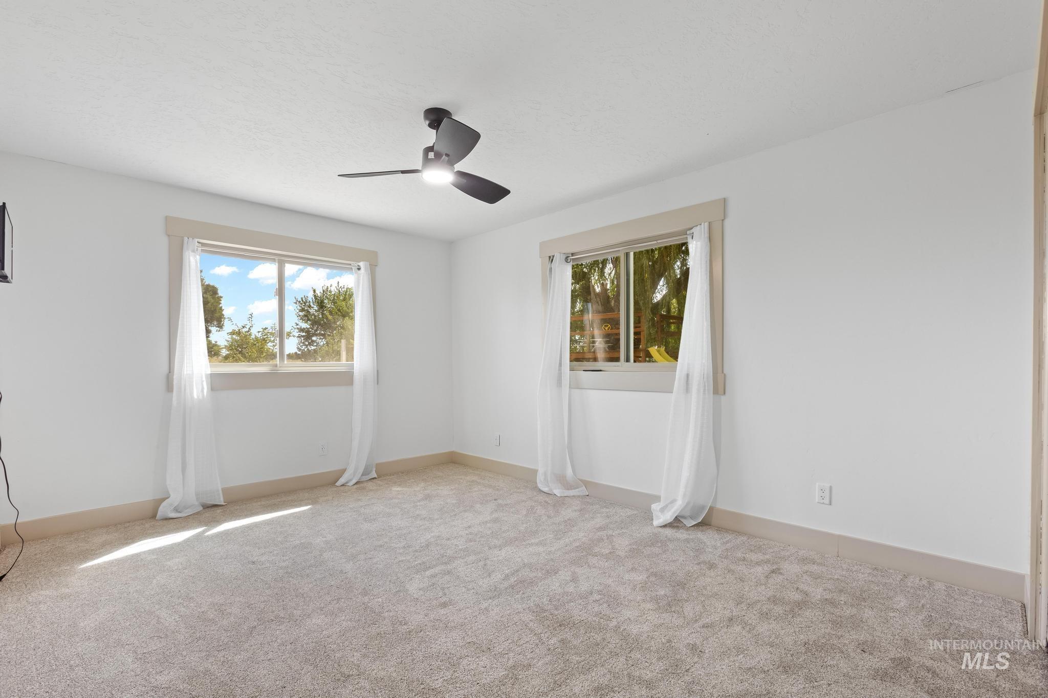8500 Washoe Road Payette, ID 83661 - Photo 43 of 50 Carpeted spare room with baseboards and ceiling fan