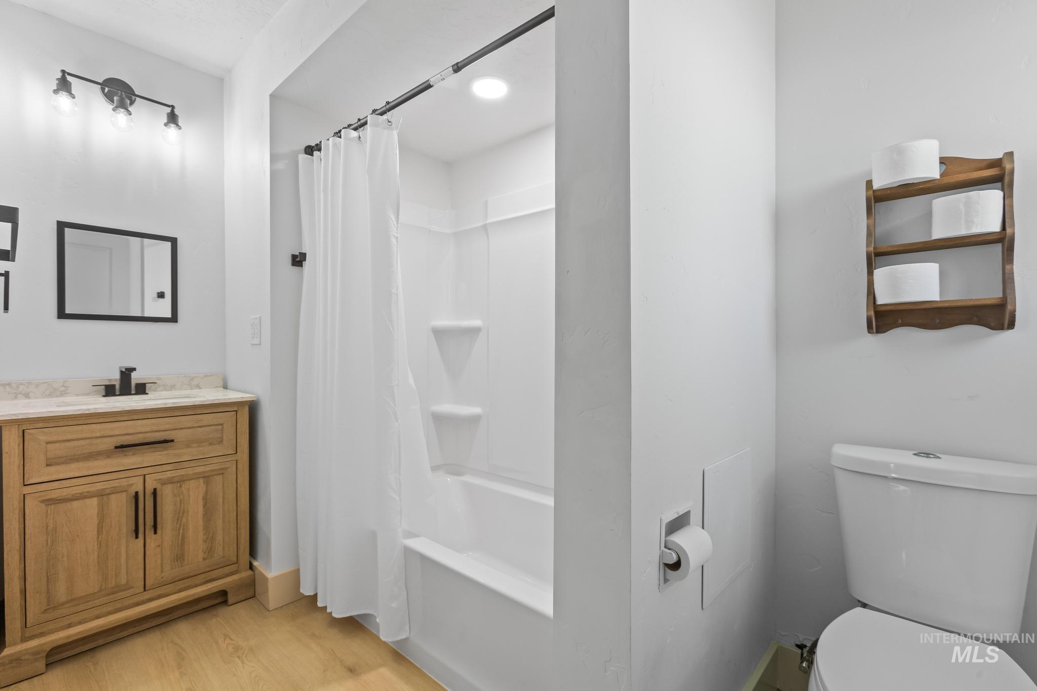 8500 Washoe Road Payette, ID 83661 - Photo 46 of 50 Bathroom featuring vanity, wood finished floors, and shower / bath combo with shower curtain