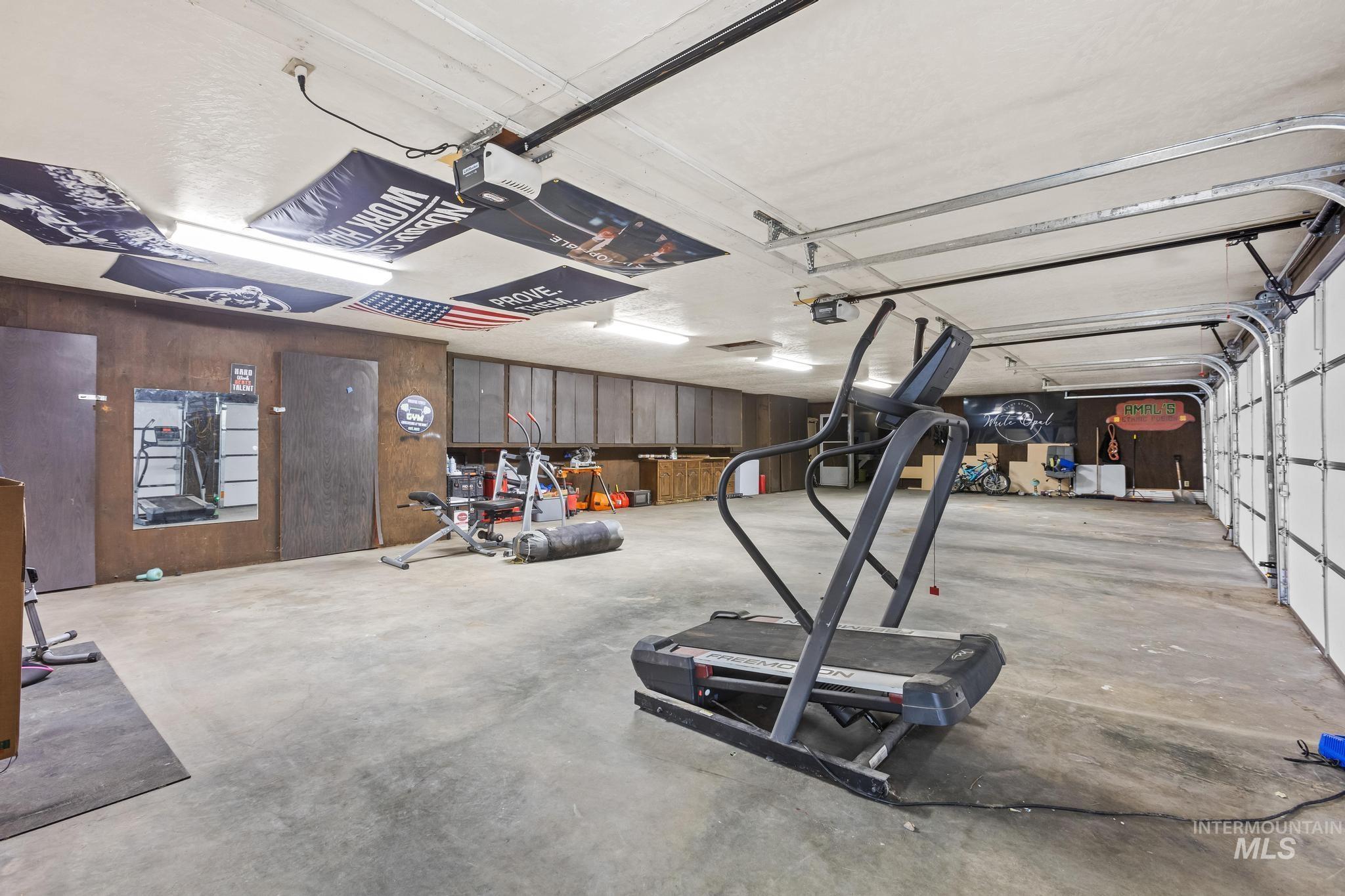 8500 Washoe Road Payette, ID 83661 - Photo 48 of 50 Garage featuring a garage door opener and wooden walls