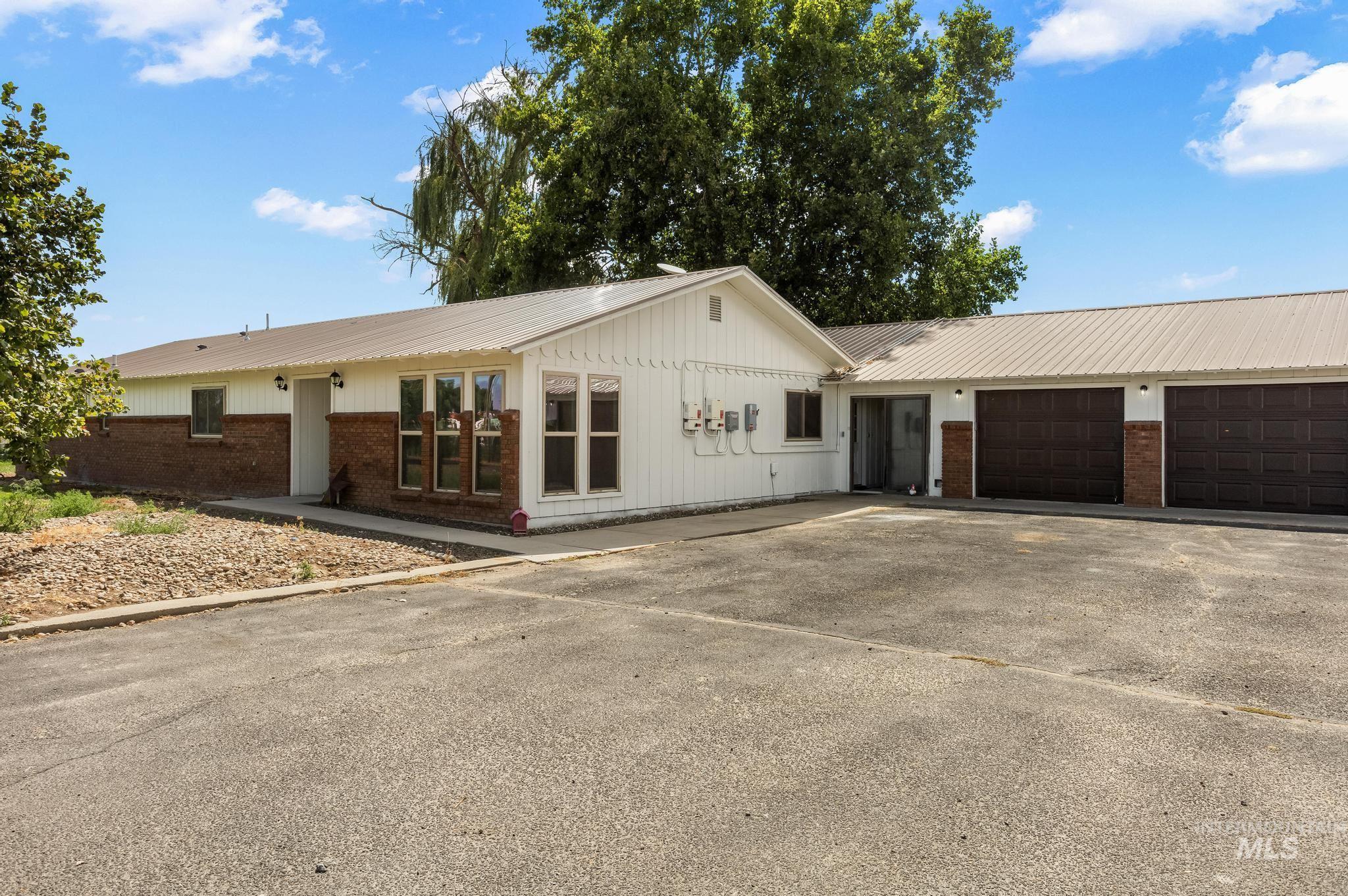 8500 Washoe Road Payette, ID 83661 - Photo 7 of 50 Ranch-style home featuring asphalt driveway, brick siding, and a garage