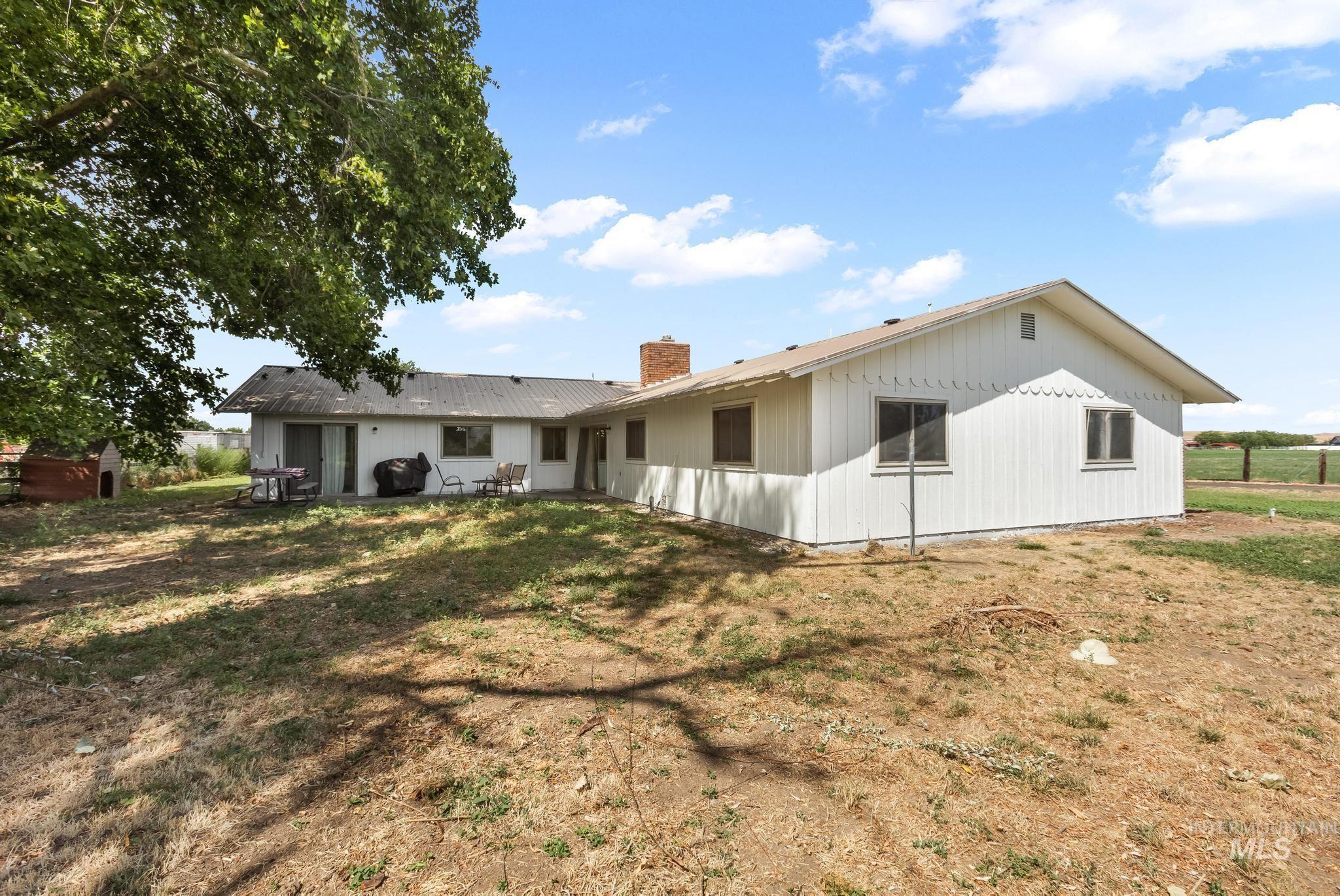 8500 Washoe Road Payette, ID 83661 - Photo 10 of 50 Back of property featuring a chimney and a yard