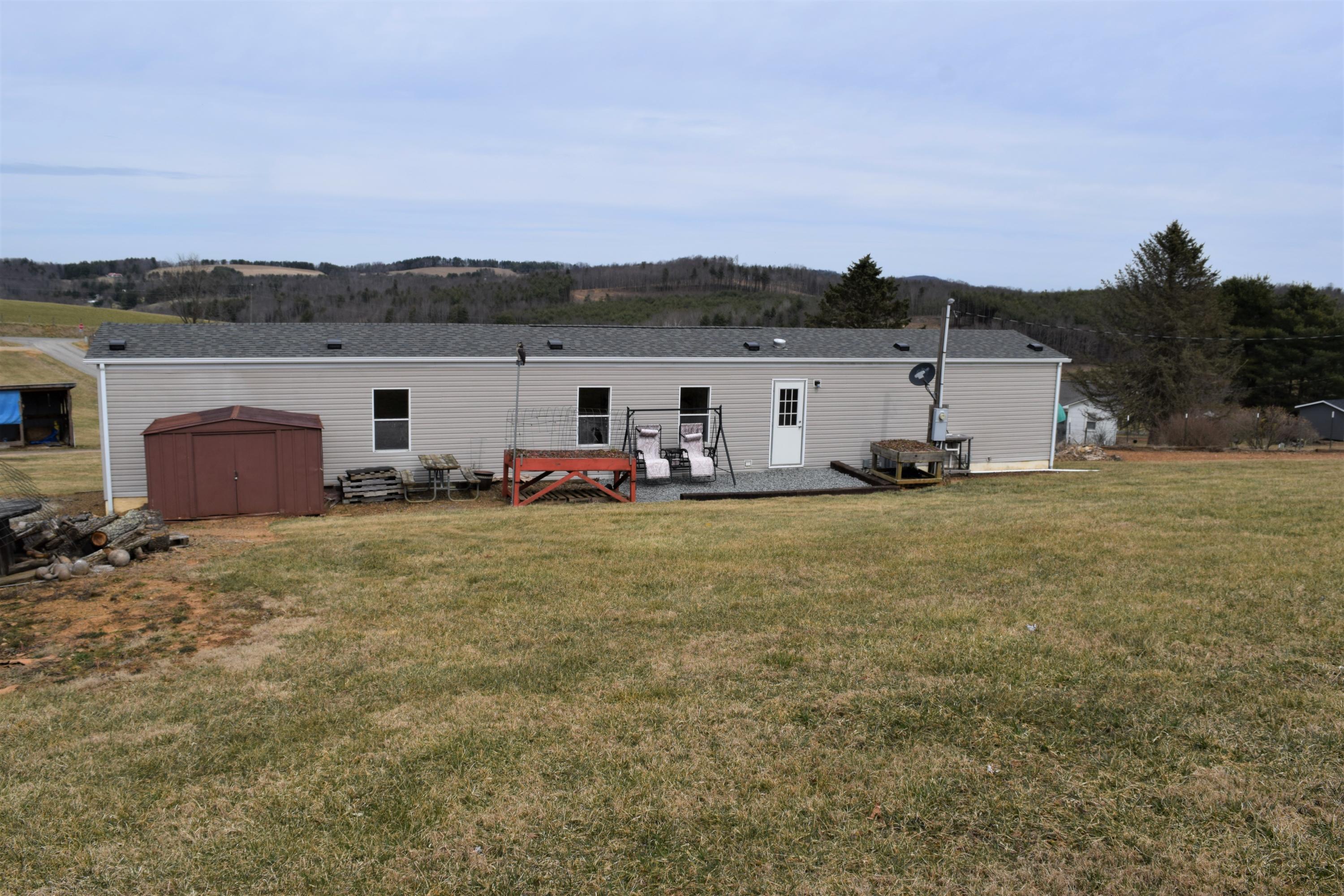 144 Weeks Road Northwest Floyd, VA 24091 - Photo 3 of 19 a view of a house with backyard and sitting area