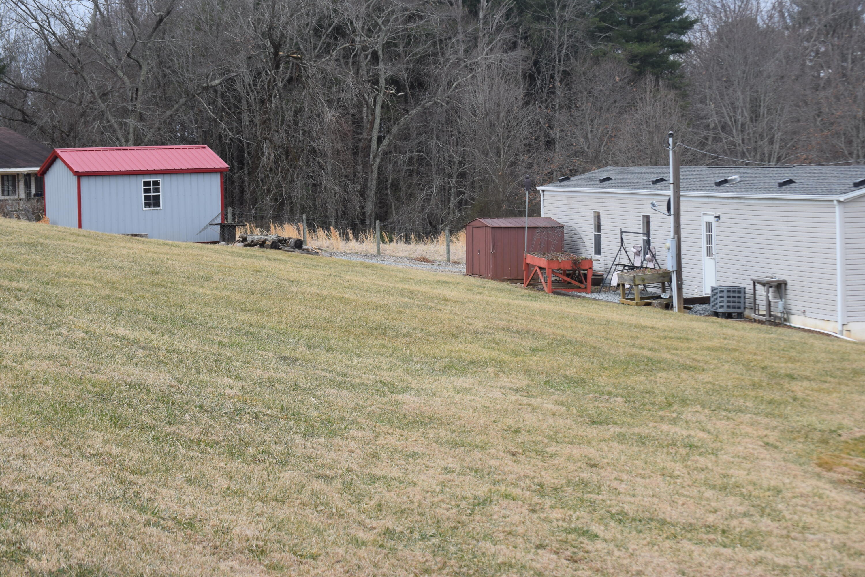 144 Weeks Road Northwest Floyd, VA 24091 - Photo 5 of 19 a front view of a house with a yard and garage