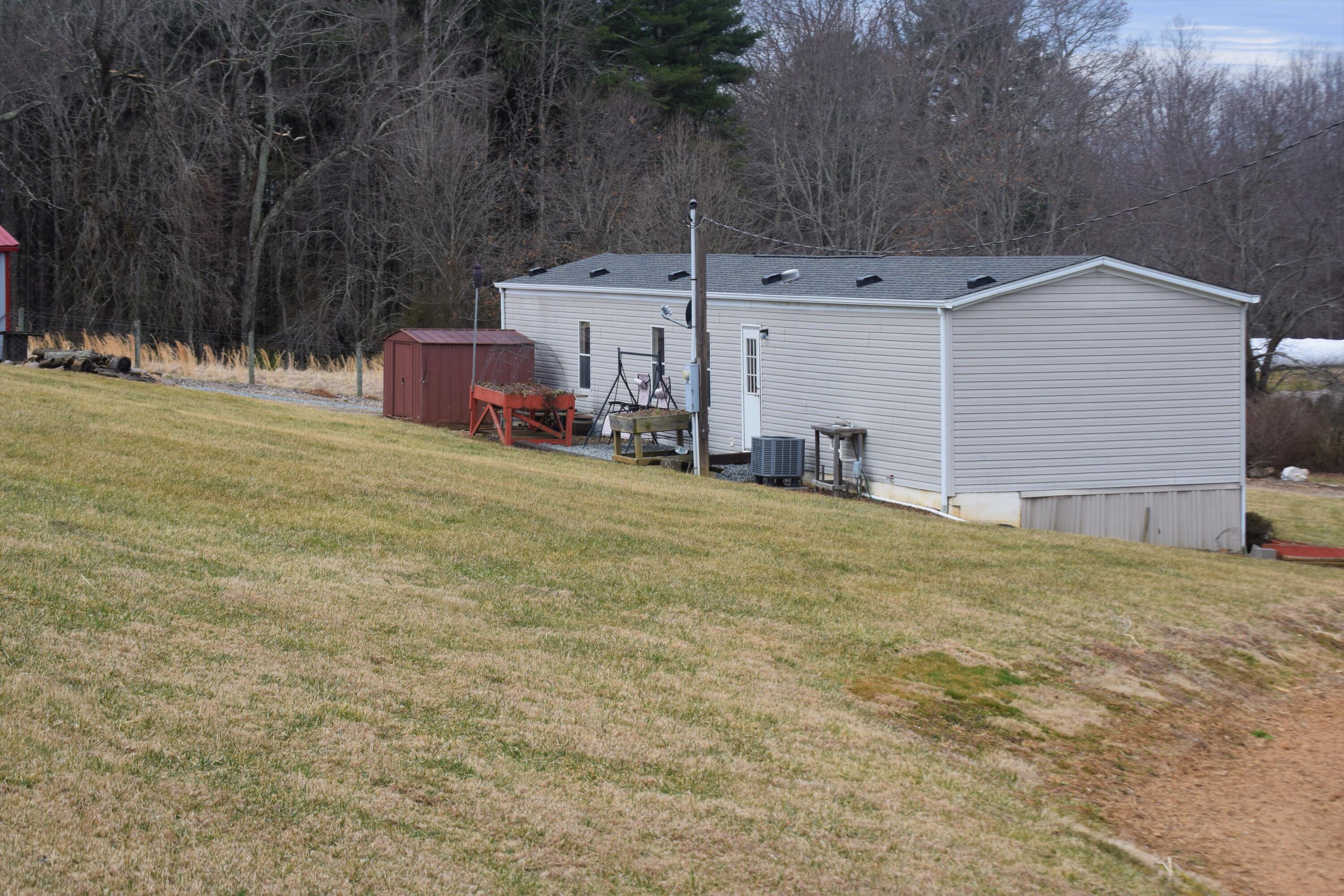 144 Weeks Road Northwest Floyd, VA 24091 - Photo 7 of 19 a backyard of a house with table and chairs