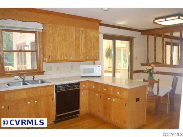 12807 Rivers Bend Road Chester, VA 23836 - Photo 8 of 10 a kitchen with a sink a window and cabinets