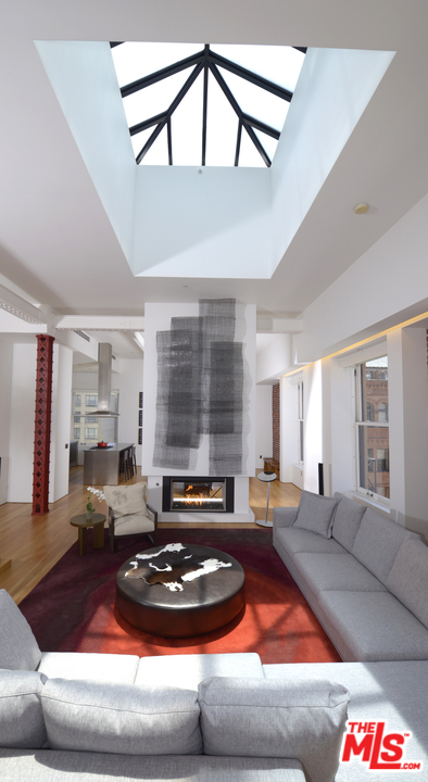 257 South Spring Street, Unit PHMN Los Angeles, CA 90012 - Photo 2 of 17 a living room with furniture and a large window