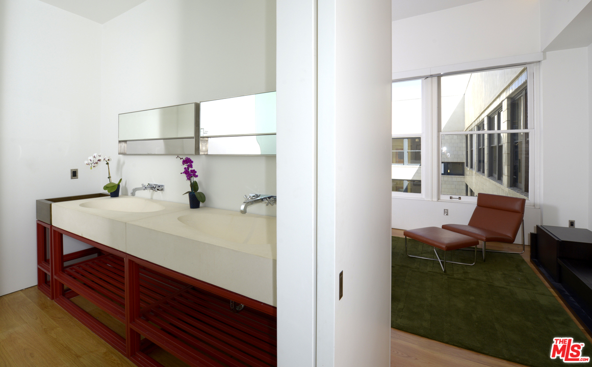 257 South Spring Street, Unit PHMN Los Angeles, CA 90012 - Photo 12 of 17 a bathroom with a sink and a mirror