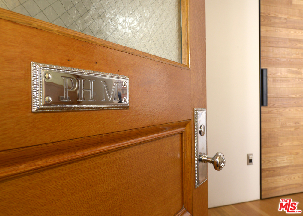 257 South Spring Street, Unit PHMN Los Angeles, CA 90012 - Photo 14 of 17 a view of a door and wooden floor