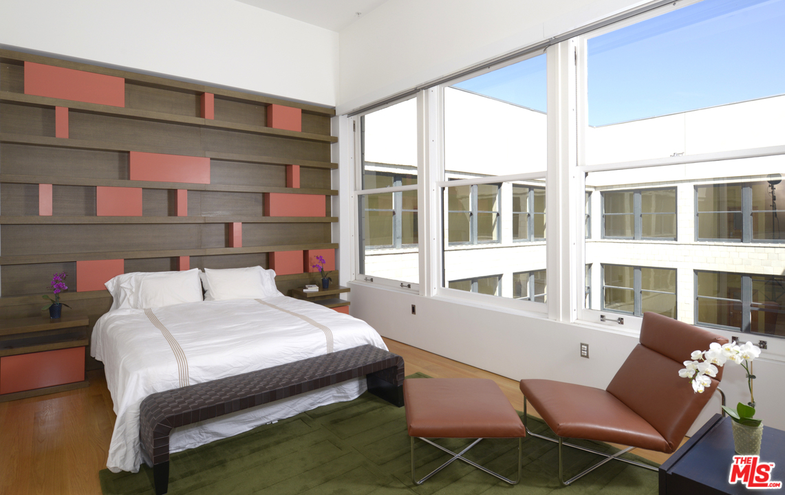 257 South Spring Street, Unit PHMN Los Angeles, CA 90012 - Photo 10 of 17 a bed room with a bed and a chair