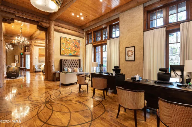 a living room with furniture and floor to ceiling windows