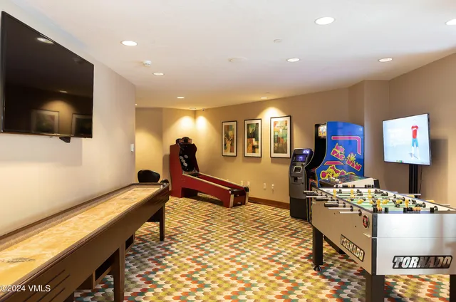 a room with furniture and air hockey table