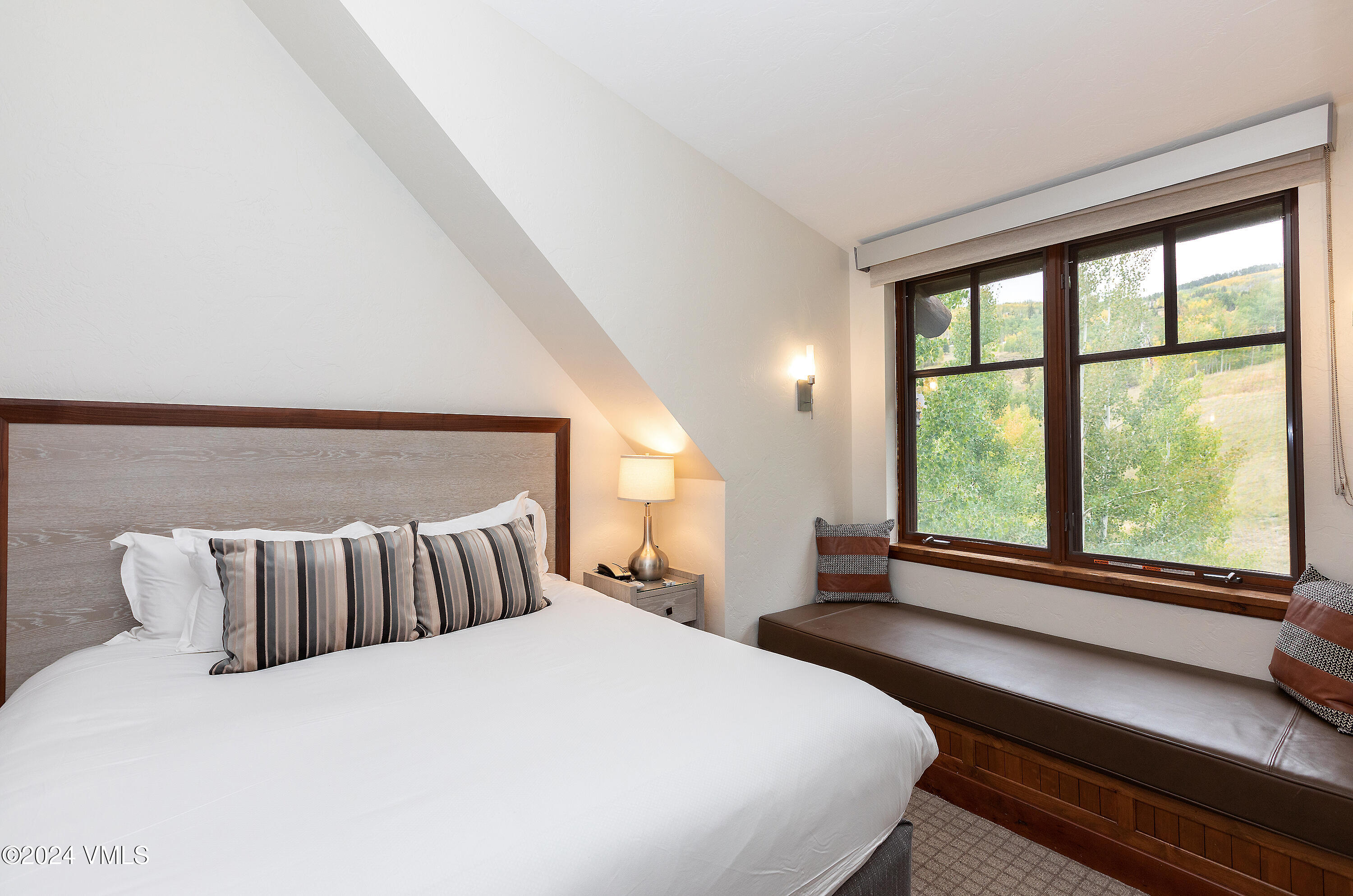 100 Bachelor Ridge Road, Unit 3208/4 Avon, CO 81620 - Photo 5 of 23 a bedroom with a large bed and a large window