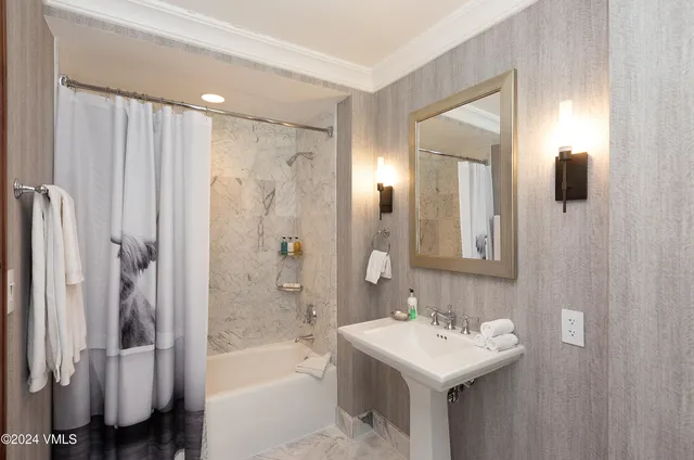 a bathroom with a sink mirror toilet and bathtub