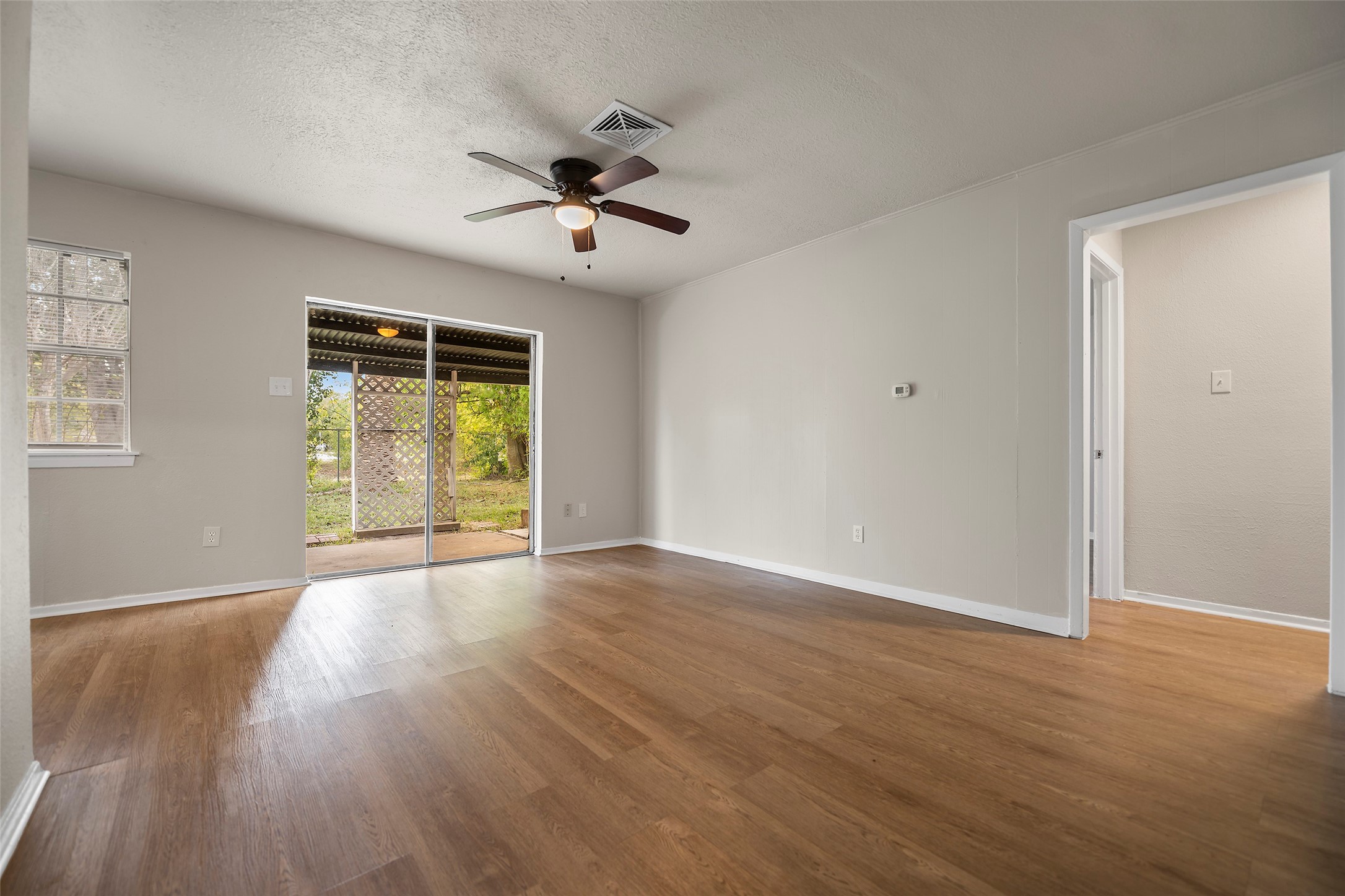13335 Ambrose Street Houston, TX 77045 - Photo 5 of 27 View of living room from entrance hallway leads to the right side of the house