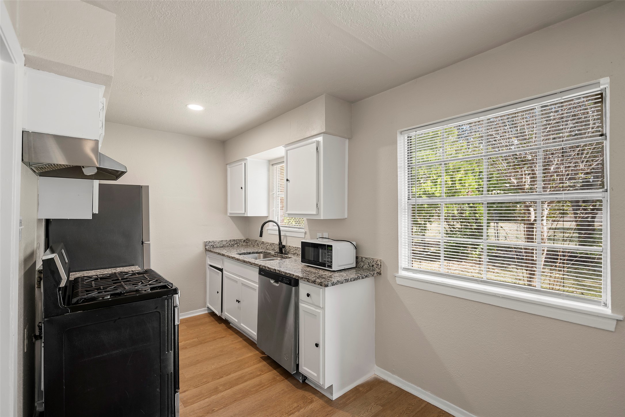 13335 Ambrose Street Houston, TX 77045 - Photo 6 of 27 kitchen and dining combo includes appliances fridge and stove