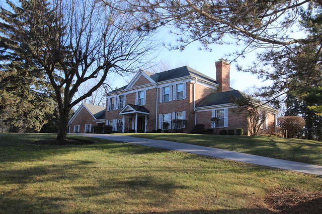 11 Deepwood Road Barrington, IL 60010 - Photo 1 of 25 a view of a large building next to a large trees with a house