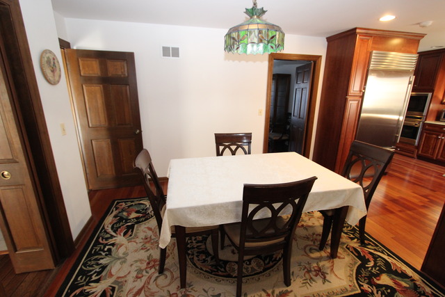 11 Deepwood Road Barrington, IL 60010 - Photo 17 of 25 a view of a dining room with furniture and a chandelier