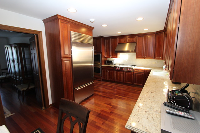 11 Deepwood Road Barrington, IL 60010 - Photo 18 of 25 a kitchen with stainless steel appliances granite countertop a refrigerator a stove and a sink