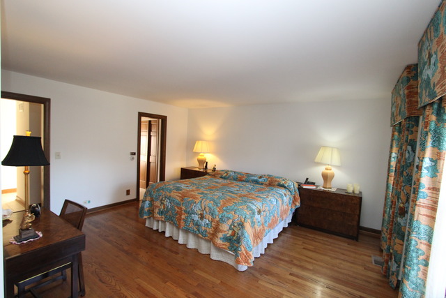 11 Deepwood Road Barrington, IL 60010 - Photo 24 of 25 a bedroom with a bed and a flat tv screen on a dresser