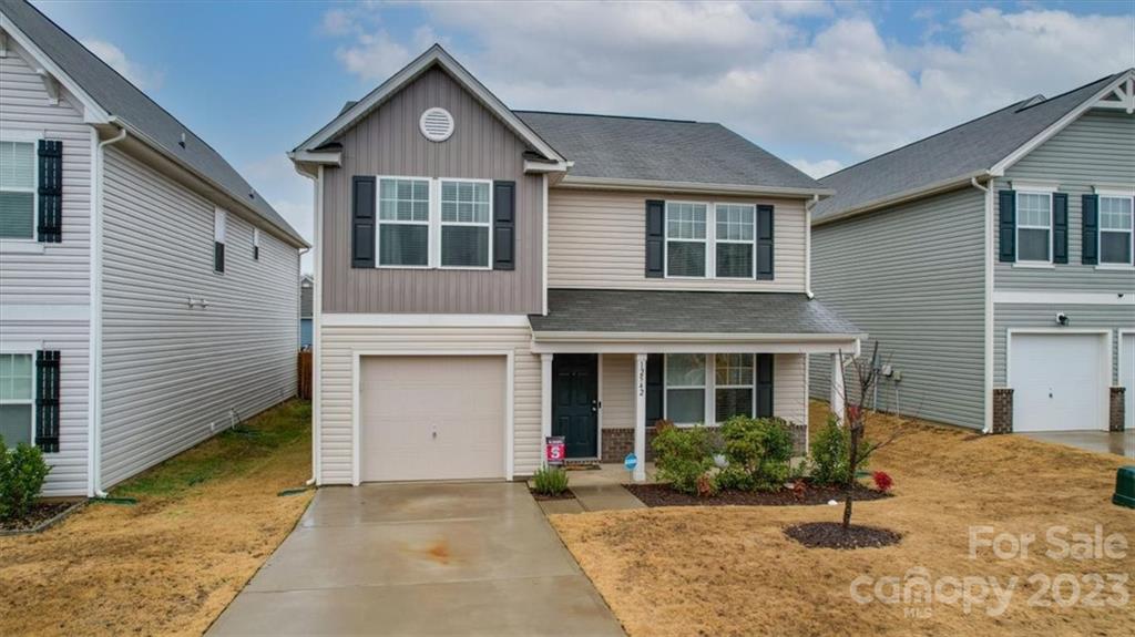 12542 Garron Road Midland, NC 28107 - Photo 1 of 38 a front view of a house with garden