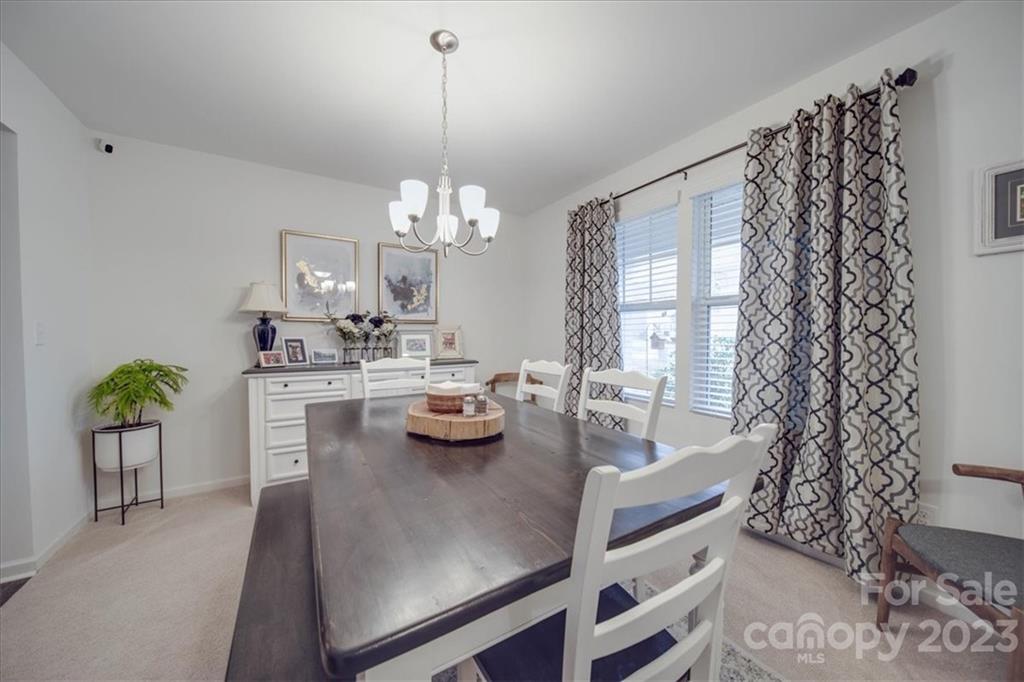 12542 Garron Road Midland, NC 28107 - Photo 17 of 38 a view of a dining room with furniture and chandelier