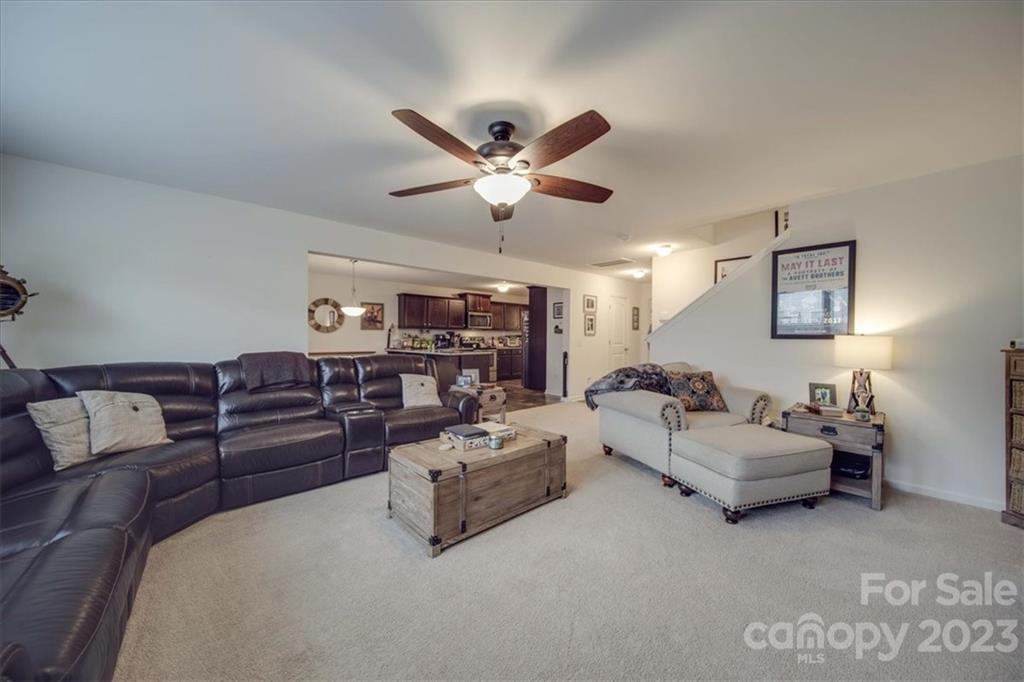 12542 Garron Road Midland, NC 28107 - Photo 32 of 38 a living room with furniture ceiling fan and a rug