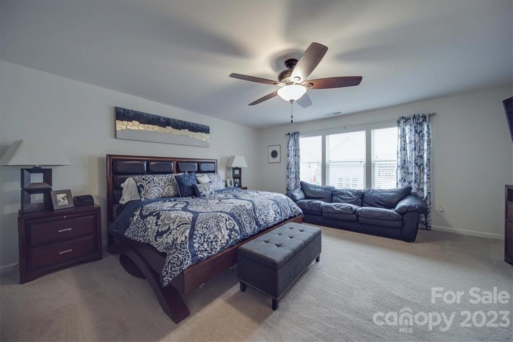 12542 Garron Road Midland, NC 28107 - Photo 36 of 38 a bedroom with a large bed and a couch