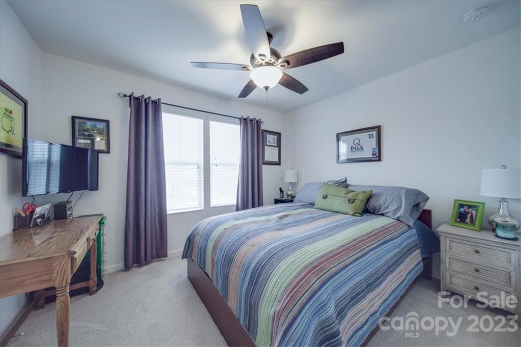 12542 Garron Road Midland, NC 28107 - Photo 7 of 38 a bedroom with a bed and a chandelier