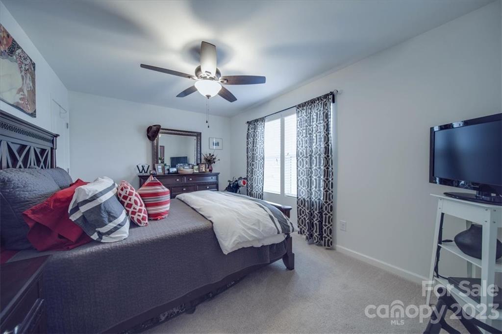 12542 Garron Road Midland, NC 28107 - Photo 8 of 38 a bedroom with a bed and a flat screen tv