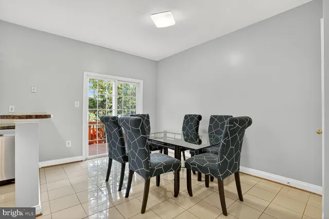 a view of a dining room with furniture and a window