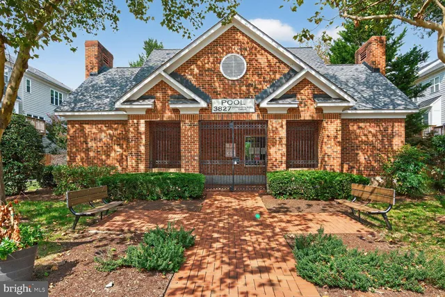 a view of a house with a small yard and floor to ceiling window