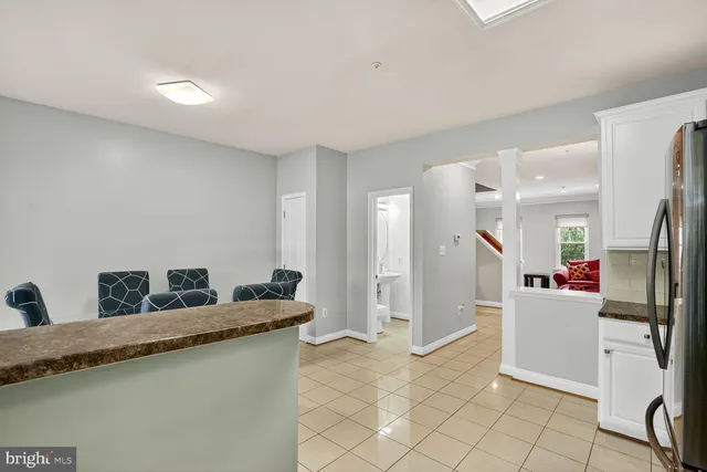 a kitchen with granite countertop a refrigerator and a sink