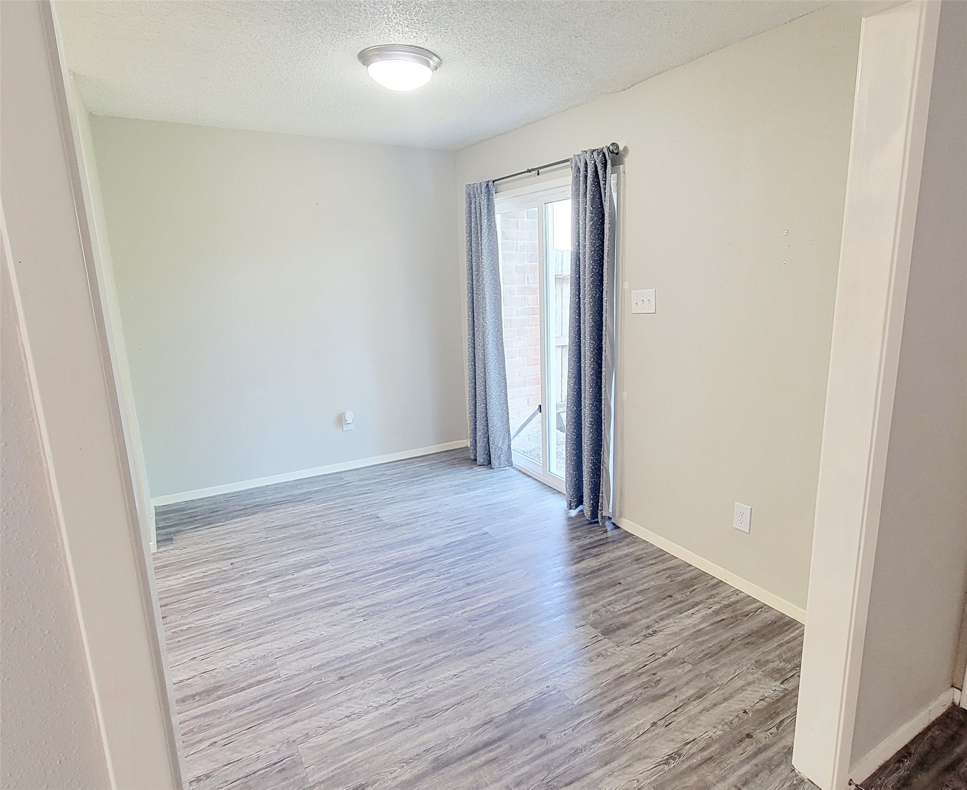 12004 Mighty Oak Drive, Unit B Houston, TX 77066 - Photo 5 of 9 an empty room with wooden floor and closet