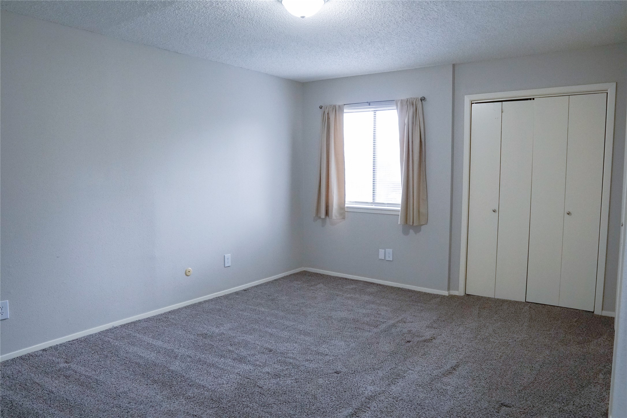 12004 Mighty Oak Drive, Unit B Houston, TX 77066 - Photo 8 of 9 an empty room with windows