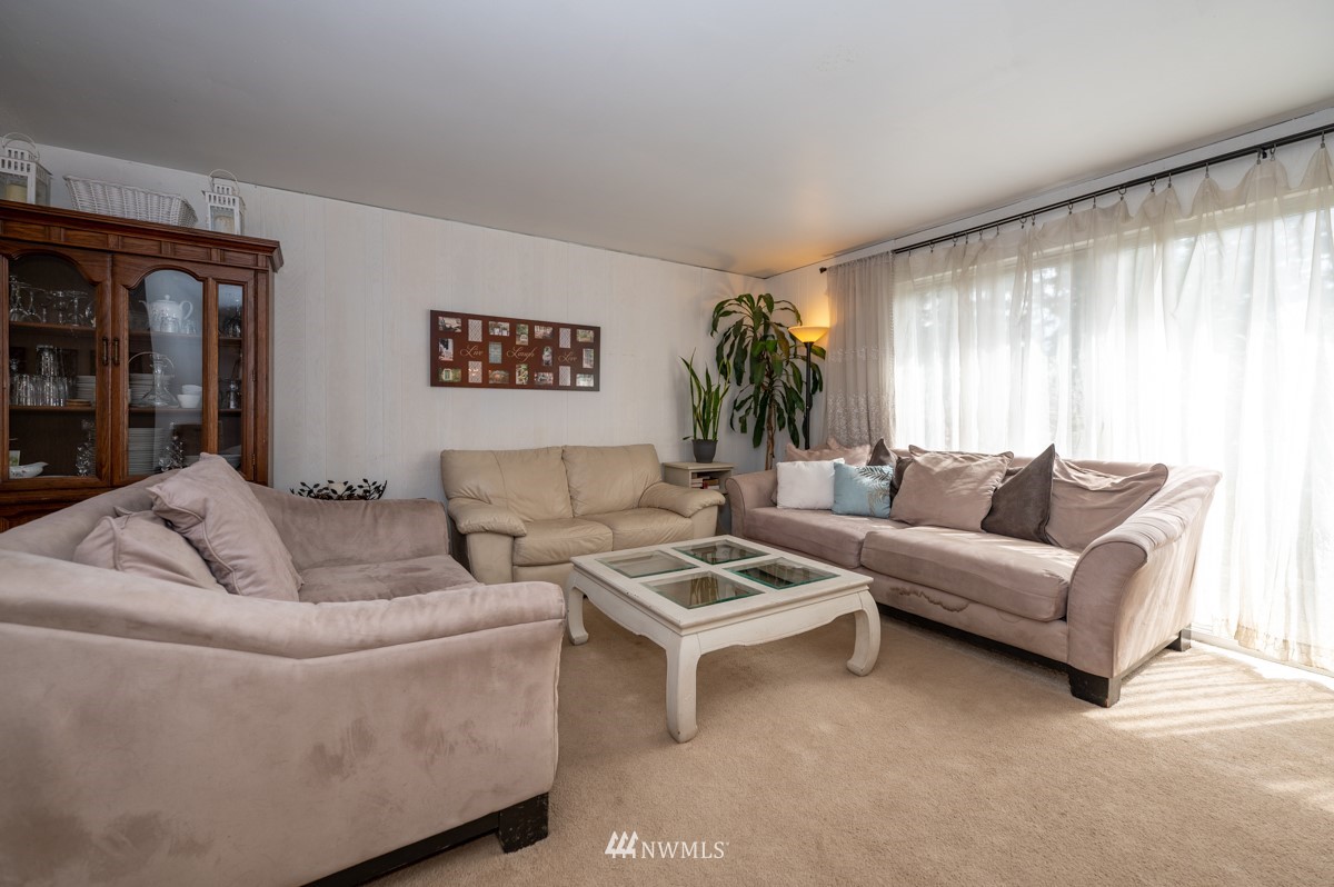 14235 169th Avenue Southeast Renton, WA 98059 - Photo 6 of 25 a living room with furniture and a large window