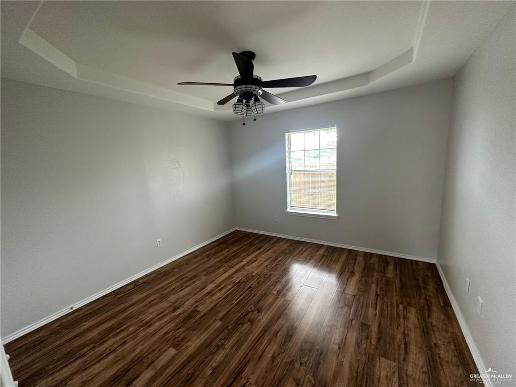 215 North 6th Street Donna, TX 78537 - Photo 5 of 16 wooden floor in an empty room with a window