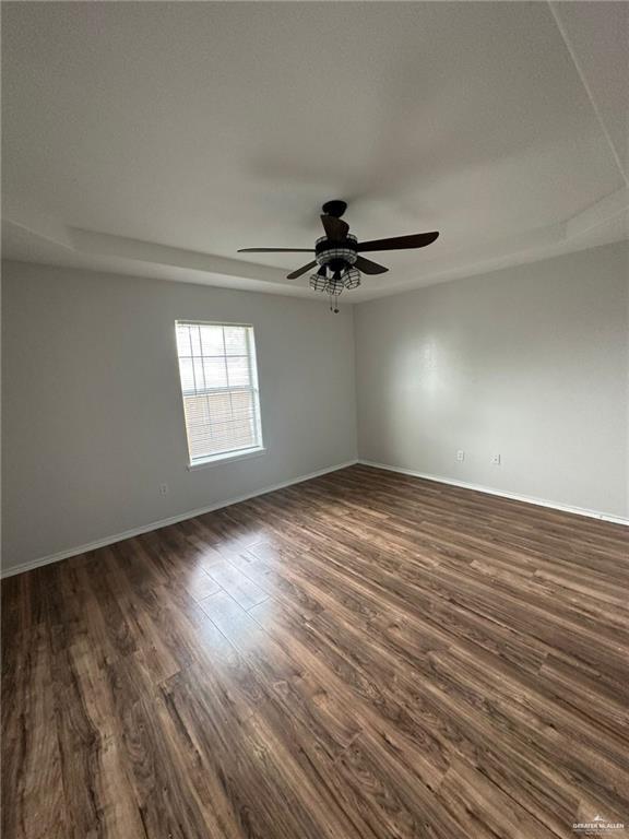215 North 6th Street Donna, TX 78537 - Photo 8 of 16 wooden floor in an empty room with a window