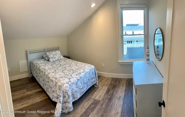 a bed sitting in a bedroom next to a window